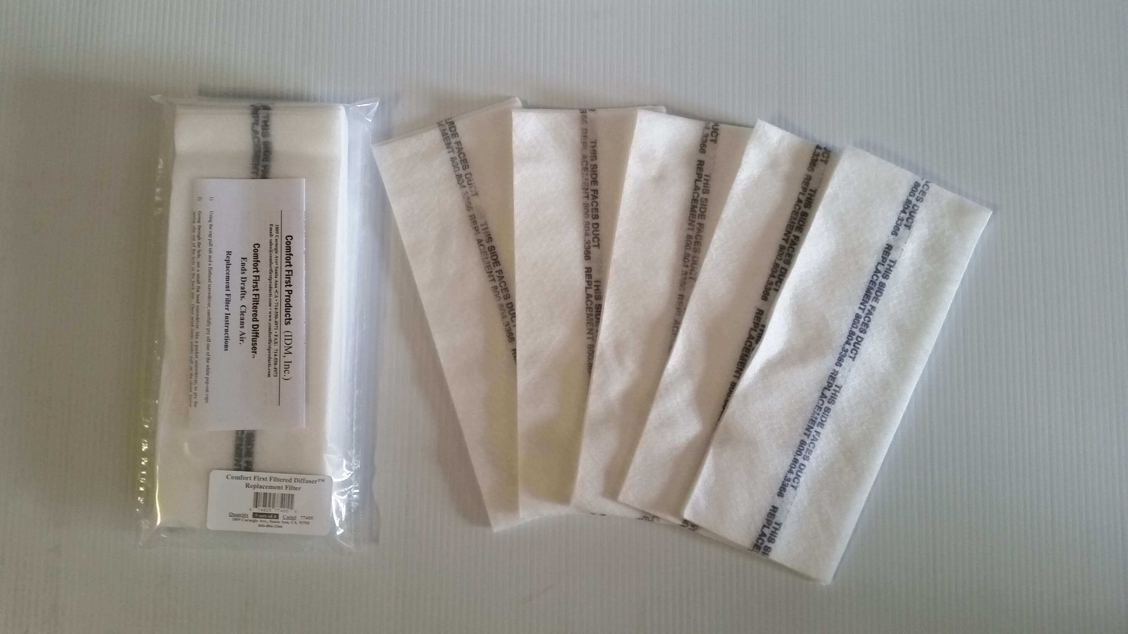 Several white sachets with text arranged in a row on a surface.