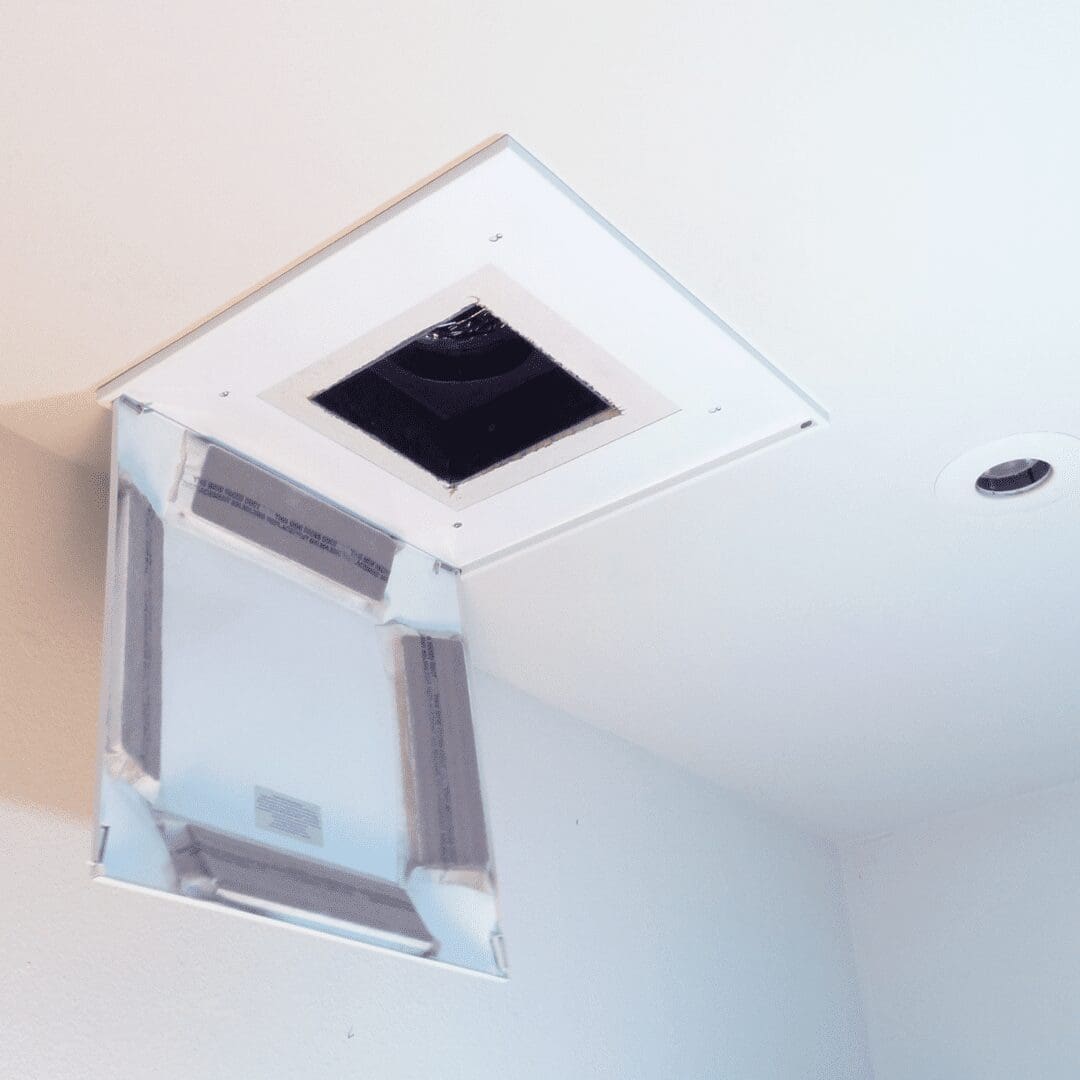 The Surface Mount Backpan CFFD 77120 has a hinged cover slightly ajar, exposing a dim interior duct space.