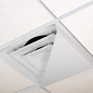 Ceiling tile removed exposing pipes and wiring.